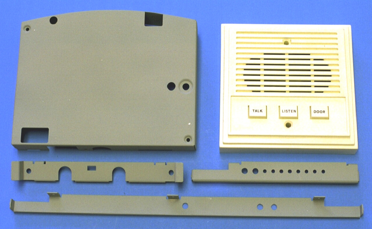 Metal stampings of telecommunications stampings and a plastic molded speaker grill